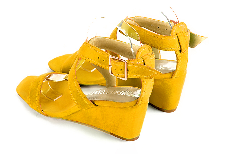 Yellow women's fully open sandals, with crossed straps. Square toe. Medium wedge heels. Rear view - Florence KOOIJMAN